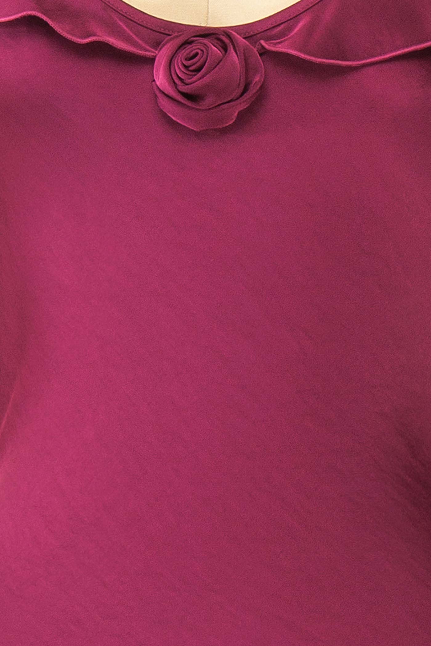 Close-up view Rhiar Burgundy Satin Maxi Dress with Butterfly Sleeves and Flower Detail at boutique 1861