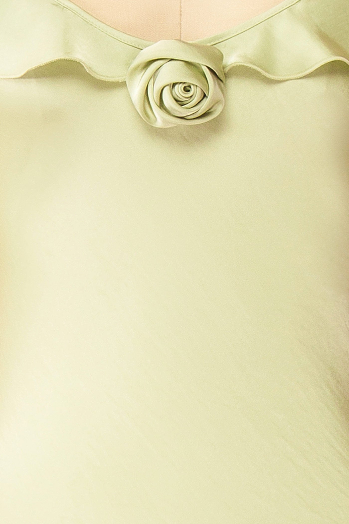 Close-up view Rhiar Sage Satin Maxi Dress with Butterfly Sleeves and Flower Detail at la boutique 1861