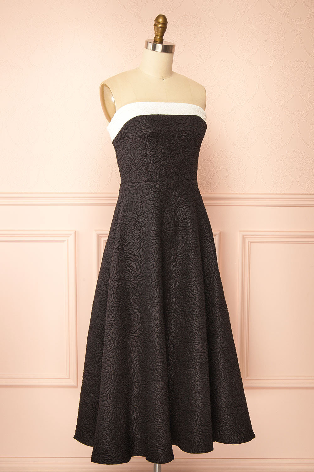side view of a mannequin wearing Solana Black Dress with Floral Waffled Texture from boutique 1861