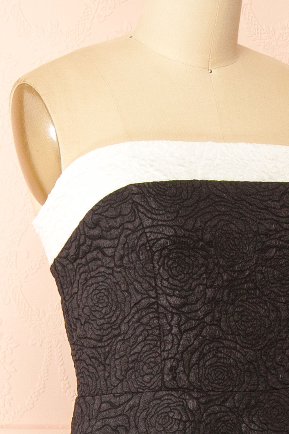 side of a mannequin wearing Solana Black Dress with Floral Waffled Texture from boutique 1861