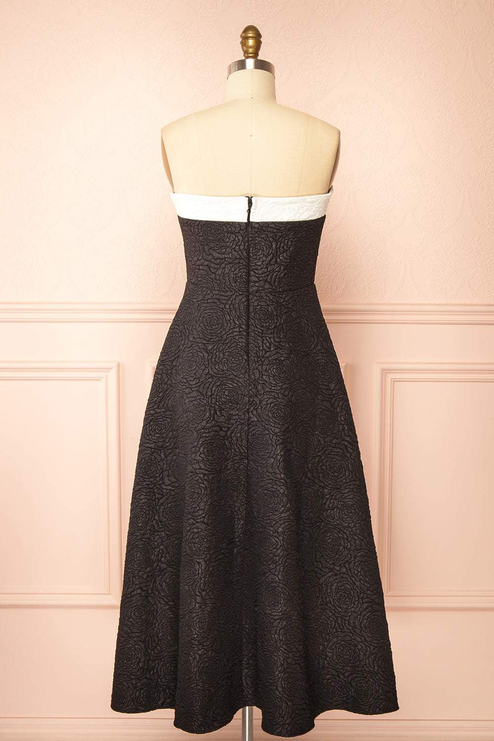 back view of a mannequin wearing Solana Black Dress with Floral Waffled Texture from boutique 1861