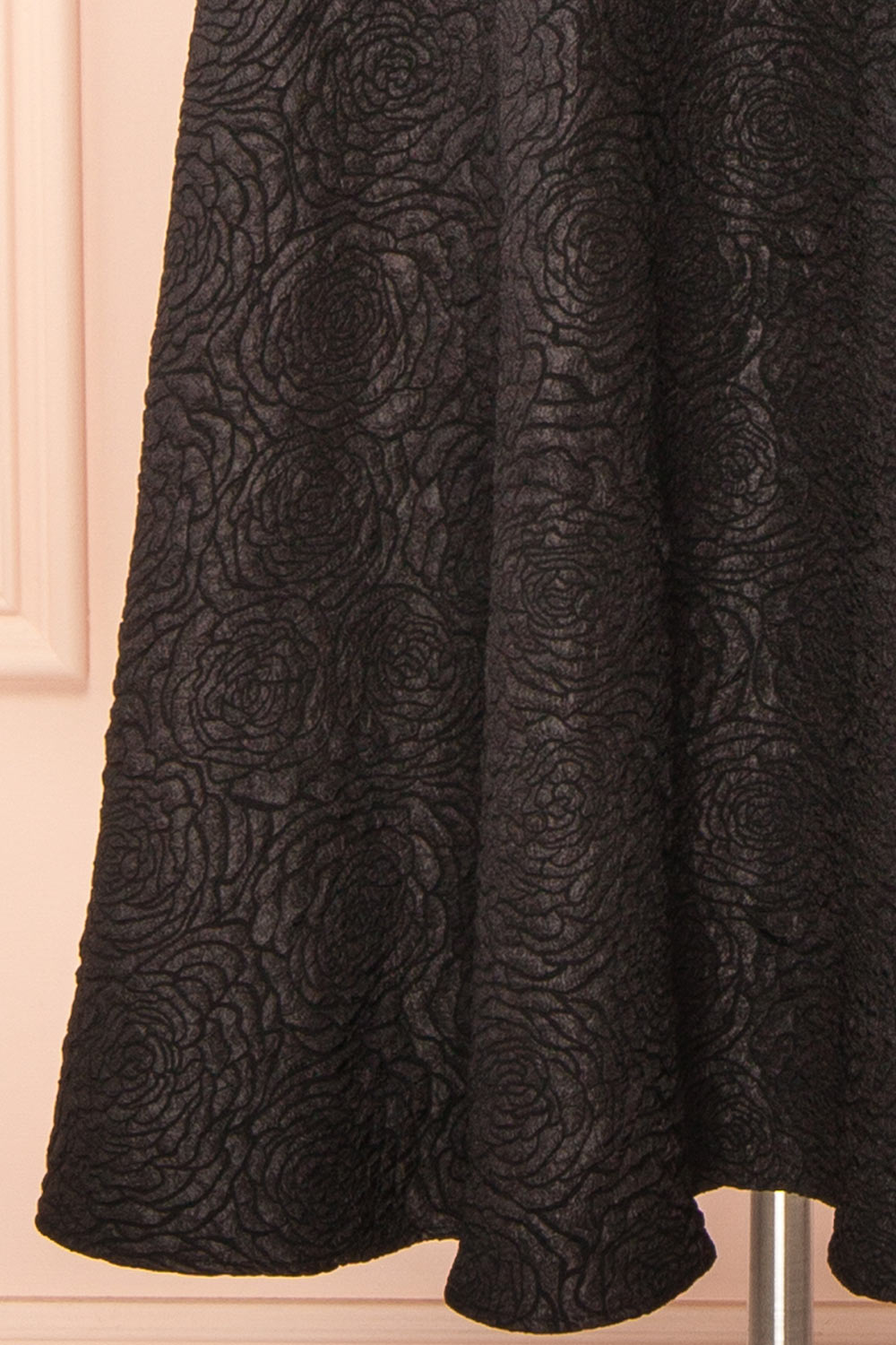 bottom of a mannequin wearing Solana Black Dress with Floral Waffled Texture from boutique 1861