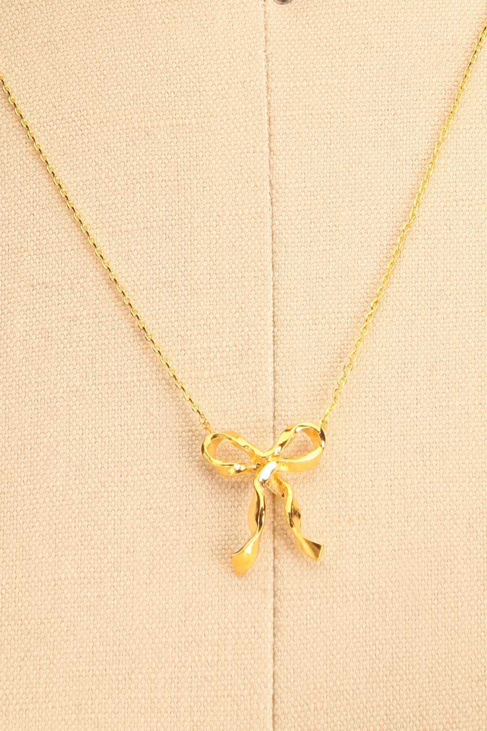 Triteia Gold Necklace w/ Bow Charm | Boutique 1861 close-up