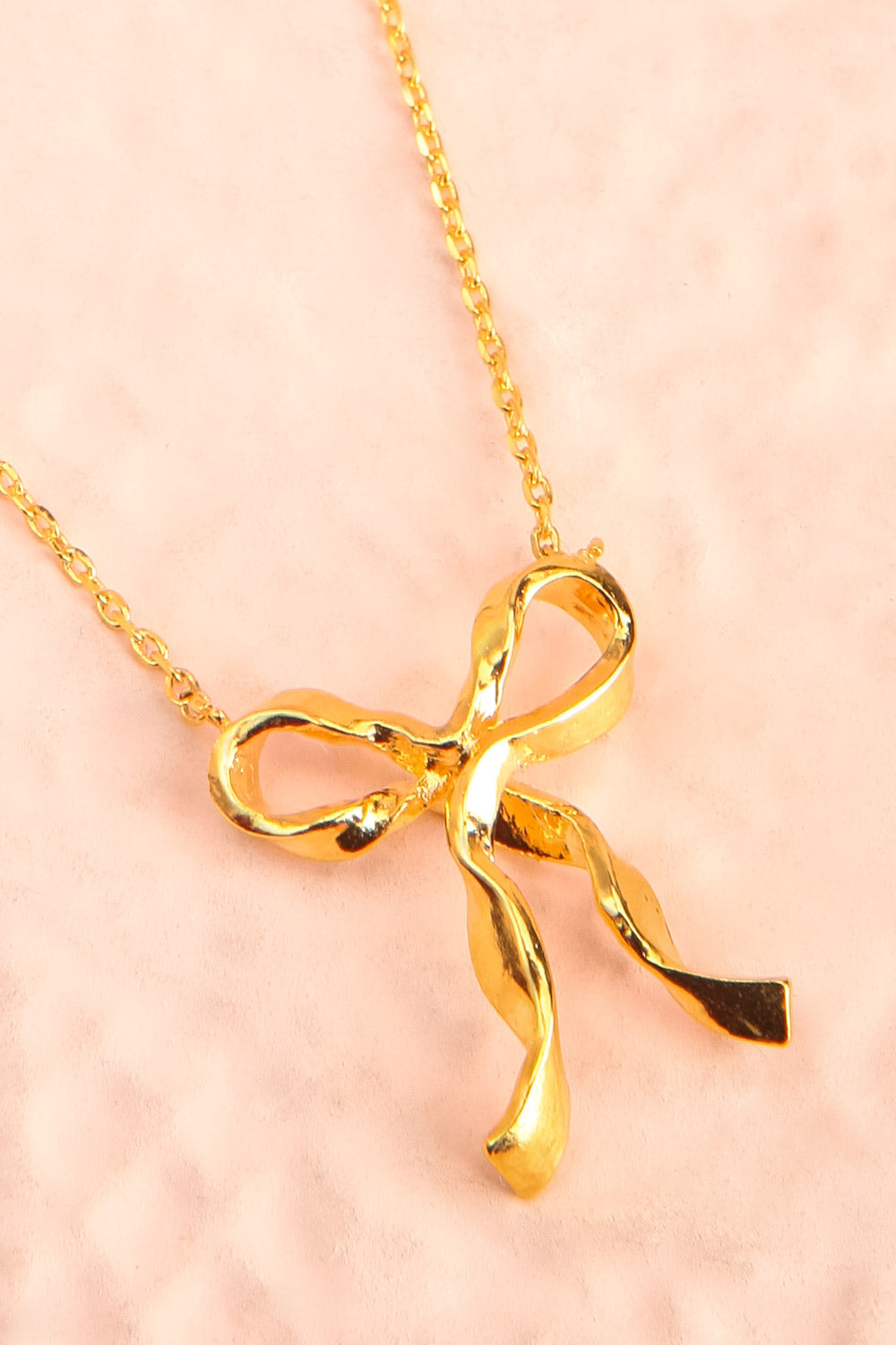 Triteia Gold Necklace w/ Bow Charm | Boutique 1861 flat close-up