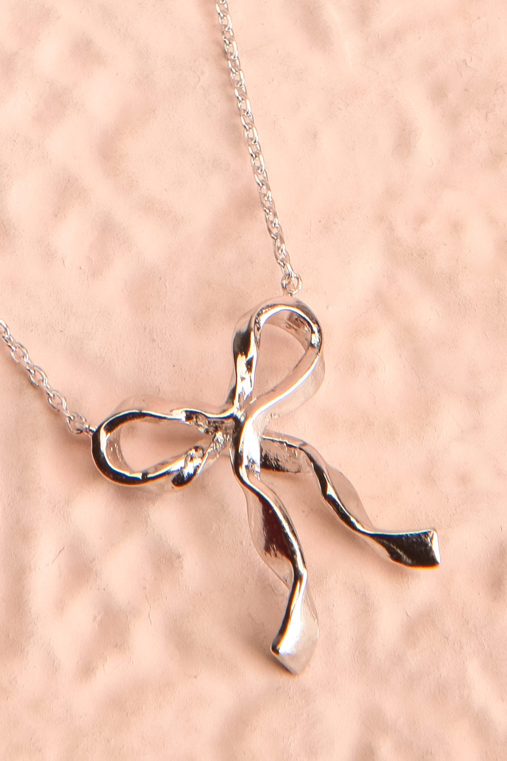 Triteia Silver Necklace w/ Bow Charm | Boutique 1861 flat close-up
