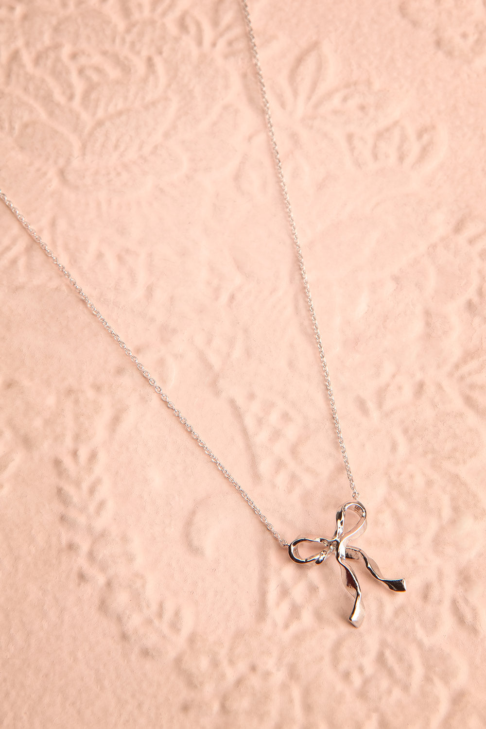 Triteia Silver Necklace w/ Bow Charm | Boutique 1861 flat view