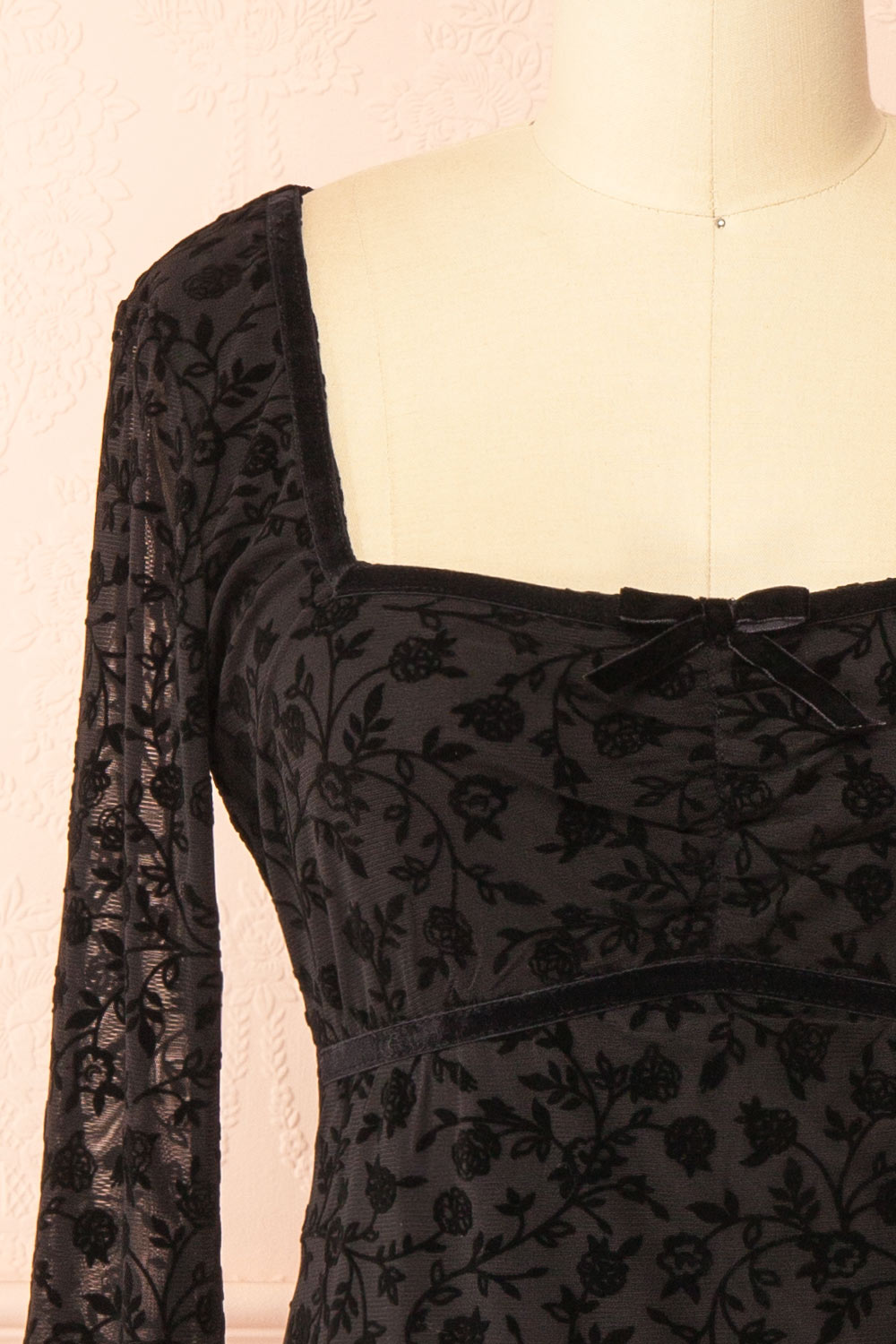 front  of a mannequin wearing a Zoeline Short Long-Sleeved Black Dress from boutique 1861