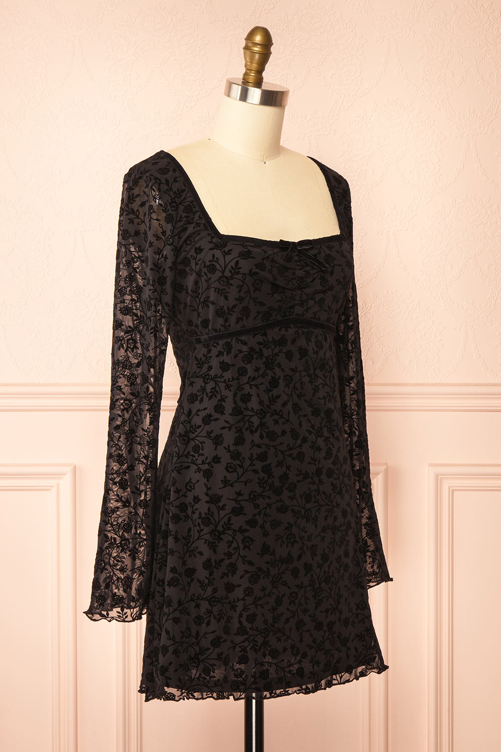 side view of a mannequin wearing a Zoeline Short Long-Sleeved Black Dress from boutique 1861