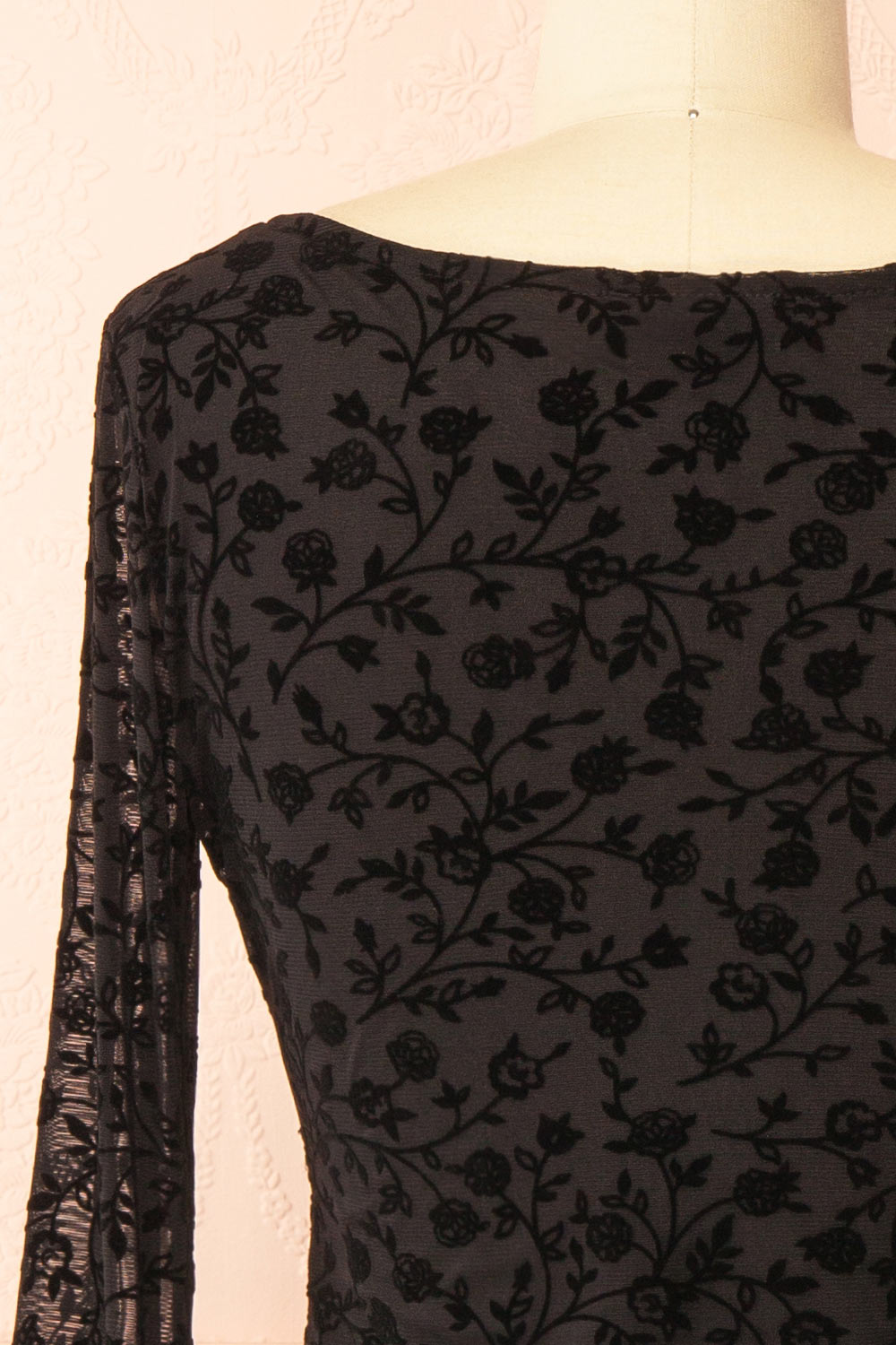 back of a mannequin wearing a Zoeline Short Long-Sleeved Black Dress from boutique 1861