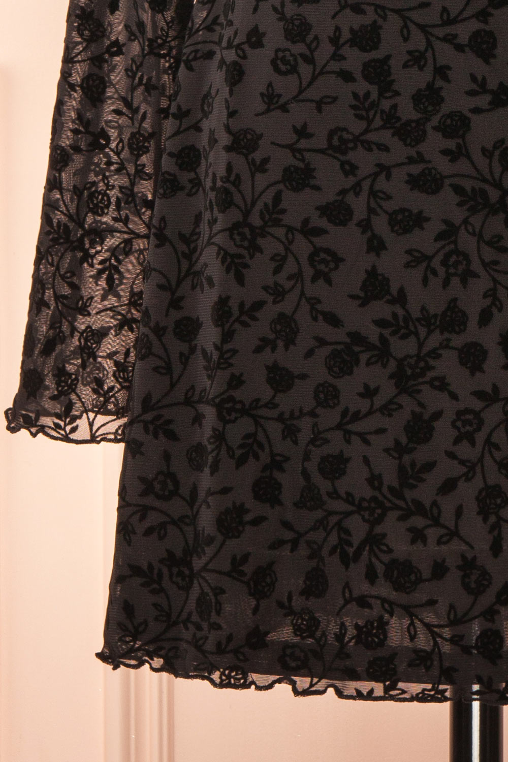 sleeve of a mannequin wearing a Zoeline Short Long-Sleeved Black Dress from boutique 1861