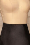 Alia Noir Black Midi Satin Skirt | Jupe side close up | La Petite Garçonne