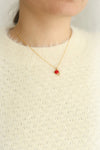 Anna Netrebko Red & Golden Pendant Necklace | Boutique 1861 on model with cream sweater