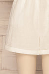 Arahal White Short Sleeved Linen Romper | La petite garçonne bottom close-up