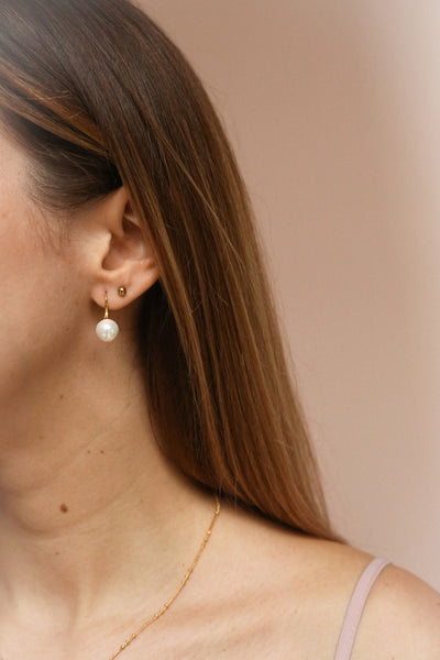 Azerro Gold Pearl Pendant Earrings | La Petite Garçonne on model with brown hair