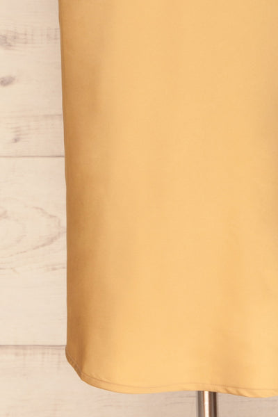 Enea Champagne Yellow Satin Midi Slip Dress | La Petite Garçonne bottom close-up