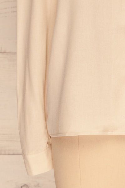 Kovin Cream Long Sleeve Blouse | La petite garçonne bottom close-up