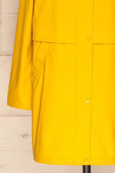 Oldham Yellow Matte Raincoat | La Petite Garçonne bottom close up