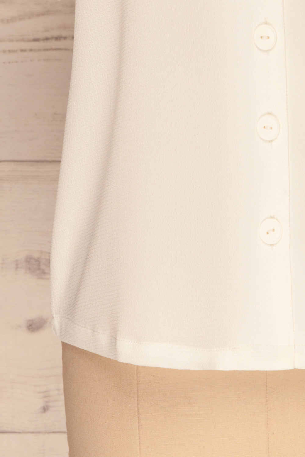 Rosarno White Crepe Short Sleeved Shirt | La petite garçonne bottom close-up