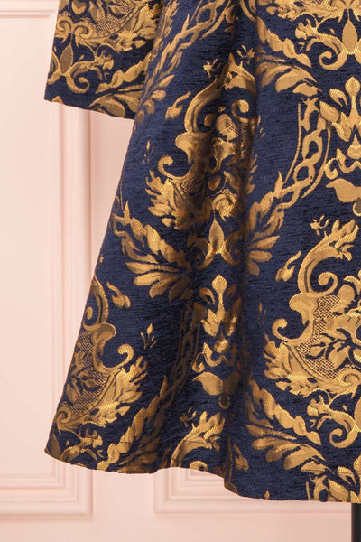 Hyleoroi Navy & Gold Jacquard Pleated Princess Coat | Boutique 1861 bottom close-up