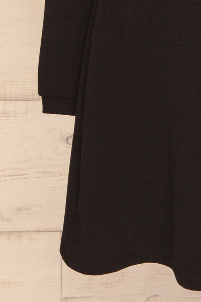 Lydie Noir Black A-Line Dress | Robe | La Petite Garçonne bottom close-up
