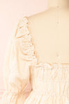 Nolla Babydoll Beige Gingham Dress w/ Flower Detailing | Boutique 1861 back close-up