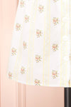 Srina Cream Floral V-Neck Buttoned Short Dress | Boutique 1861 bottom