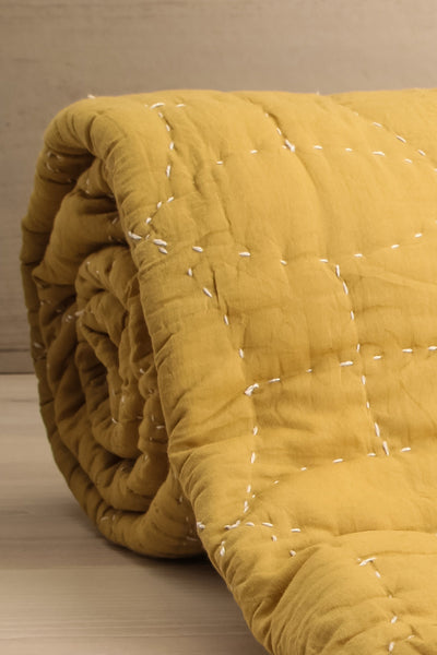 Tegue Chartreuse Yellow Quilted Throw Blanket | La petite garçonne rolled close-up